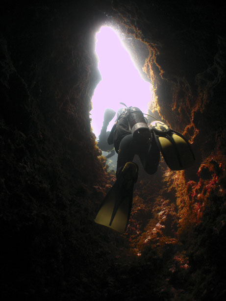Passing through the chimney at The Blue Hole